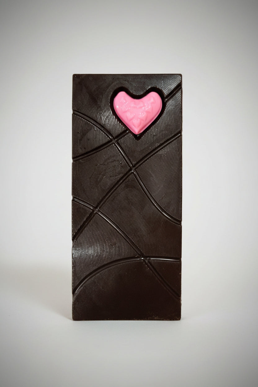 Pink heart on a textured green surface