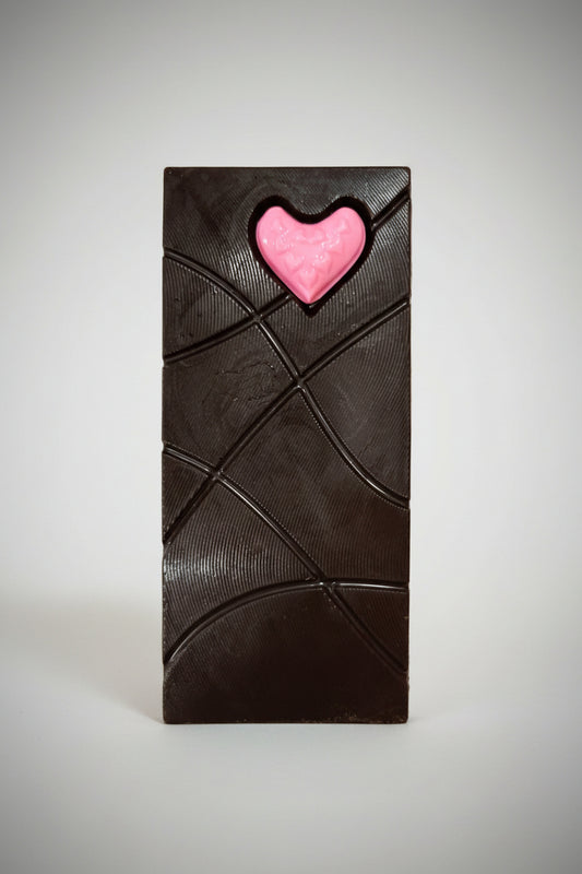 Pink heart on a textured green surface
