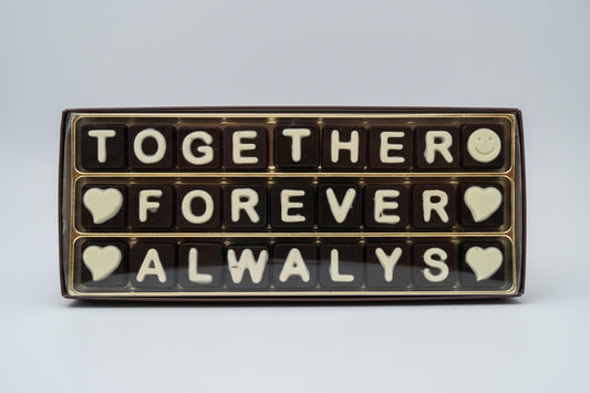 Chocolate letters spelling 'TOGETHER FOREVER ALWAYS' in a decorative box.